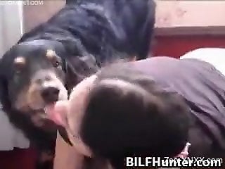 Black t-shirt brunette sucking this big dog cock